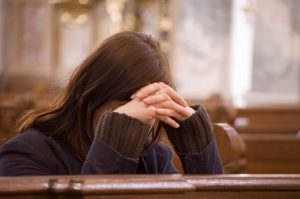 Desperate Woman in Church Praying